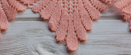 knitted lace. The material is folded randomly on a horizontal surface. Sample of fabric. Beige lace