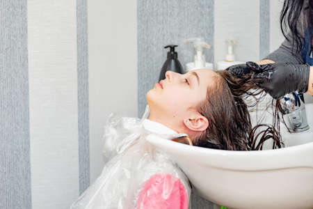 Teenage girl in a beauty salon on hair coloring and a haircut. Beauty concept. child, hairdressing,の写真素材