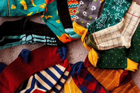 Colorful sock on gray background, top view. Knitted socksの写真素材