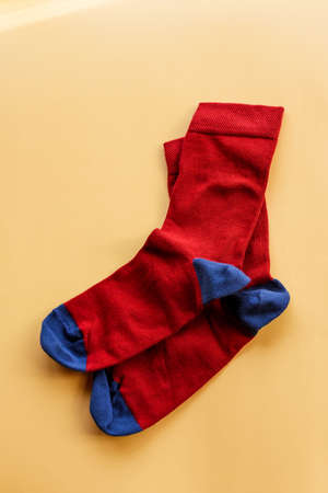 Colorful sock on beige background, top view. Knitted socksの写真素材