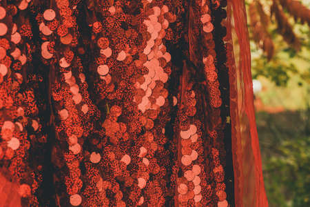 red sequins textile background. glitter fabric. red background fabric shiny christmas festiveの写真素材