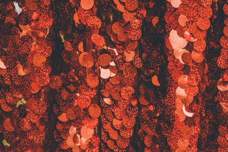 red sequins textile background. glitter fabric. red background fabric shiny christmas festiveの写真素材