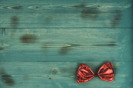 wooden serving tray. Green wood tray. Red bow on a green backgroundの写真素材