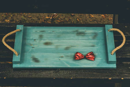 wooden serving tray in the background of nature. Green wood tray. green wood table wooden Red bowの写真素材