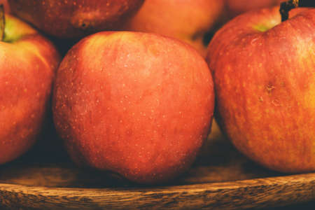 Red apples in a wooden plate on dark background. apple red wooden fruit sweet healthy food