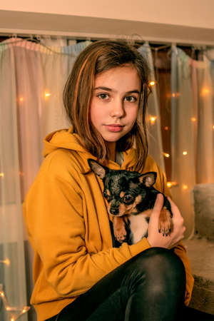 Teenage girl with a chihuahua in her arms. dog, girl, chihuahuaの写真素材
