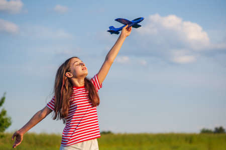 Young teenage girl holding a airplane. Dream. Freedomの写真素材