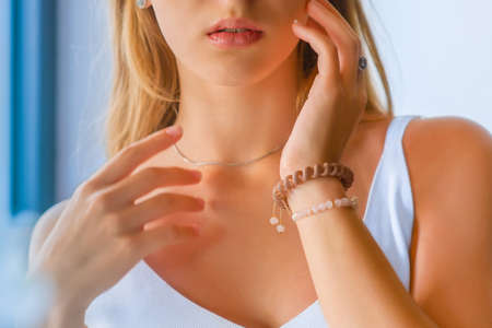 close-up portrait of beautiful girl's lower part of face and manicured fingers. Girl's lips and handsの写真素材