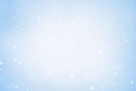 Defocus light white and blue glitter. Blurred focus of blue sparkles.の写真素材