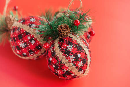 Christmas. New Year's toys made of fabric decorated with a Christmas tree on a red background.