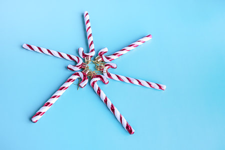Christmas toy lollipop on a blue background. Christmas composition, New Year's ornament.の写真素材