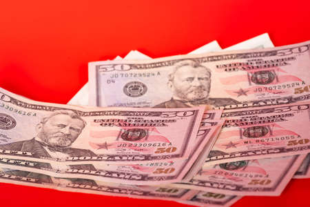 financial concept. Paper money American dollars a lot on a red background.