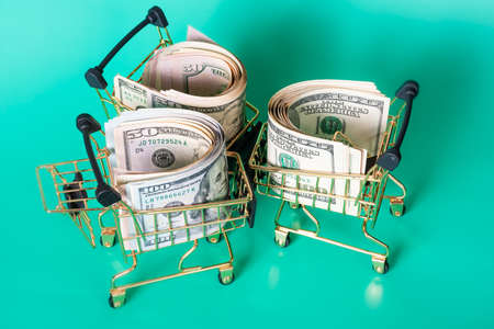American dollars on a green background. Finance, business and banking. Dollars in a cart.の写真素材