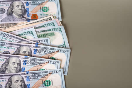 Many American dollars on a olive color background. business, wealth.