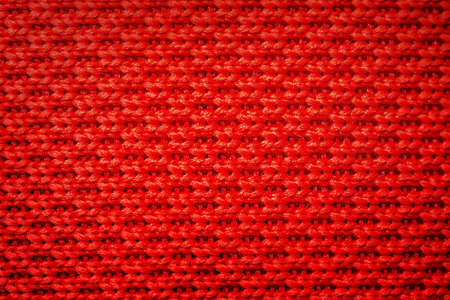Abstract red background. Red knitting fabric weaving as background.の写真素材