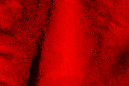 Red suede texture. Red matte background of suede. Velvet texture of seamless leather.の写真素材