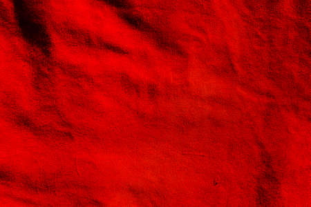 Red suede texture. Red matte background of suede. Velvet texture of seamless leather.