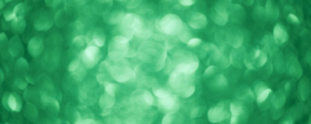 Round defocuses on a blurred background. Green glitter background defocus light.の写真素材