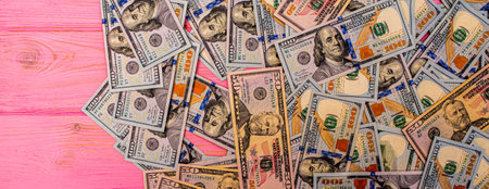 American dollars. Dollars on a wooden table. Money on a pink wooden background.の写真素材