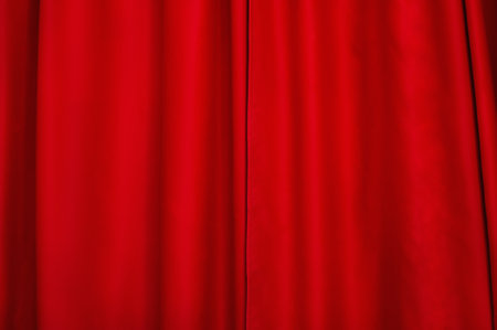 Red fabric as a background. The window is closed with a curtain. Red light-absorbing curtain.の写真素材
