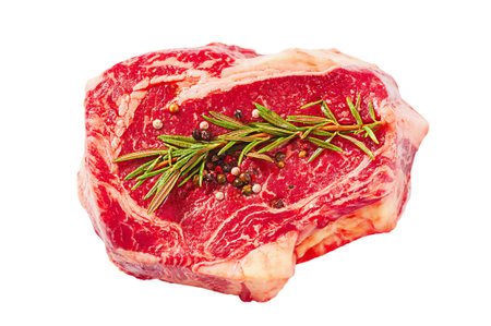 Raw beef steak with sprig of rosemary and peppers isolated on white.の写真素材