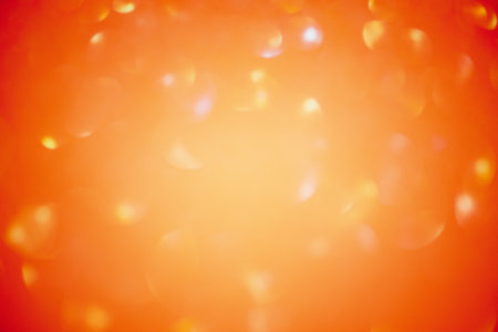 Glitter paper defocus as background. Sparkles defocus light. Orange background and yellow defocus.の写真素材