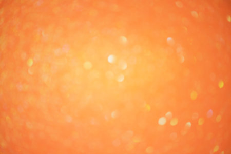 Glitter paper defocus as background. Sparkles defocus light. Orange background light and shadow.の写真素材