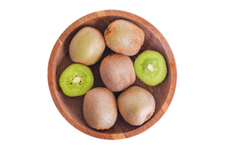 Kiwi fruit whole and cut in a wooden plate isolated on whiteの写真素材