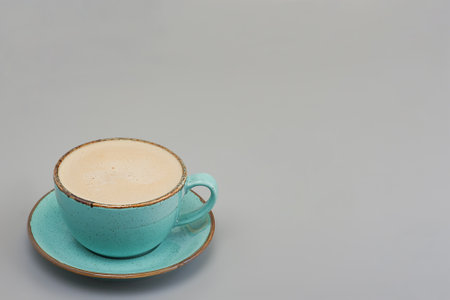 Cup of coffee with milk on a gray background. Cappuccino, latte.の写真素材