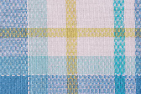 Checkered blue with yellow and white color fabric backgroundの写真素材