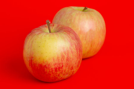Two red apples on a red background. Fruits, applesの写真素材