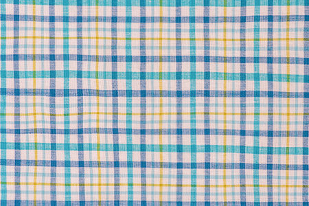 Checkered fabric in blue, white and yellow as a backgroundの写真素材