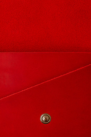 Red leather suede wallet as a background macro photo