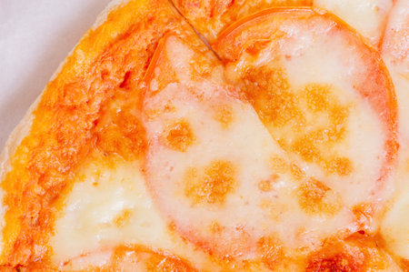 Pizza macro photo with tomatoes, sauce and cheese. Pizza deliveryの写真素材