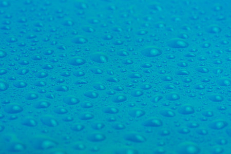 Blue plastic with water drops macro photo. Abstract blue backgroundの写真素材