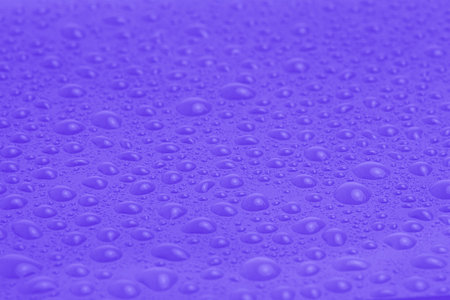 Texture of water drops on purple plastic as a backgroundの写真素材