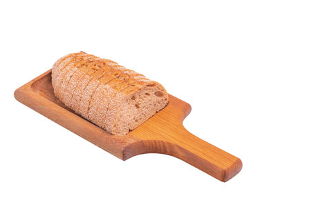 Buckwheat baguette sliced on a wooden board isolate
