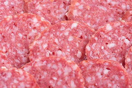 Sliced smoked sausage as a background thin focus part