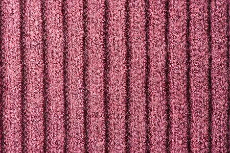Burgundy knitted background. Burgundy fabric texture macro photo as background