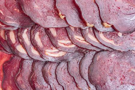 Delicious raw dried sausage macro photo as a backgroundの写真素材