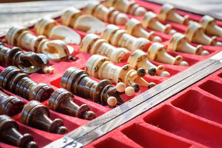 Black and white carved wooden chess pieces. Playing wooden chess piecesの写真素材