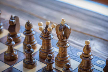 Black chessmen on a chessboard. Playing wooden chess pieces. Let's play chessの写真素材