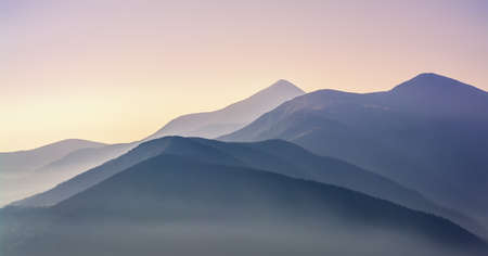 Beautiful sunrise in the Carpathians. Hill lines during sunrise. beautiful natural landscape. Vibrant photo. panoramic view.の写真素材