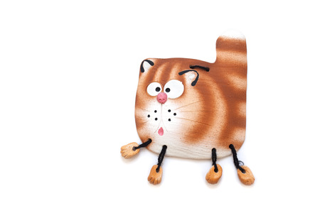 Funny cartoon cat clay souvenir isolated on white backgroundの写真素材