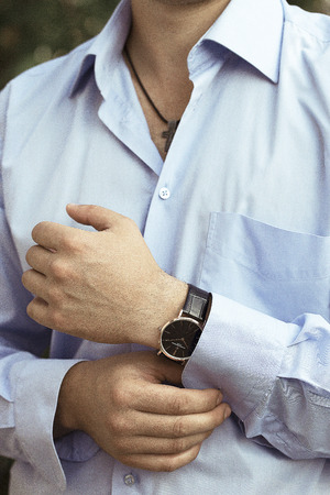 sexy man in luxury blue shirt and rist watchの写真素材