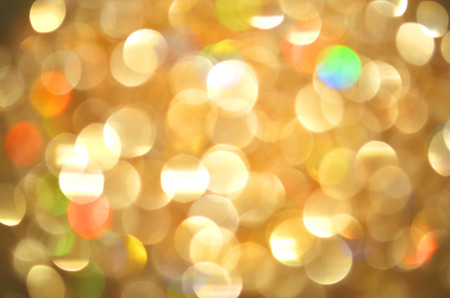 Bokeh gold colour abstract background. Glittering stars on golden Christmas background.の写真素材