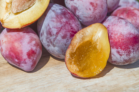 Plums on the wooden table. Summer  fresh plumsの写真素材