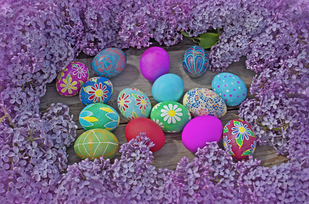 Easter eggs and  lilac  on a old wooden background