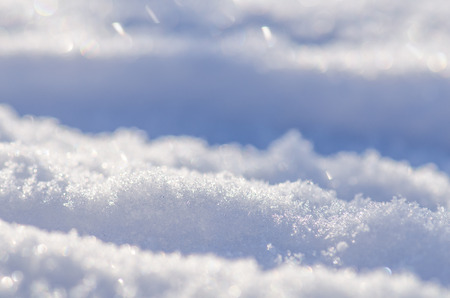 Background of fresh snow. Natural winter background. Snow texture in blue toneの写真素材