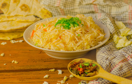Sauerkraut on ceramic white plate on wooden table.の写真素材
